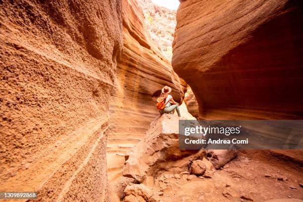 tourist exploring a canyon in grand canary. canary islands, spain - isla de gran canaria fotografías e imágenes de stock