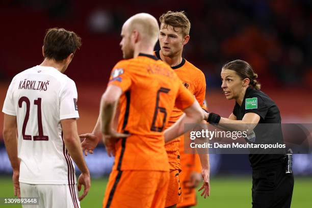 Referee, Stephanie Frappart speaks to Matthijs de Ligt of Netherlands and Kriss Karklins of Latvia during the FIFA World Cup 2022 Qatar qualifying...