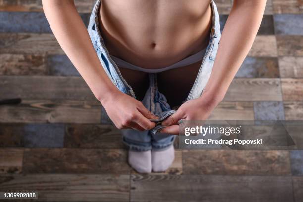 young woman losing weight - too big stock pictures, royalty-free photos & images