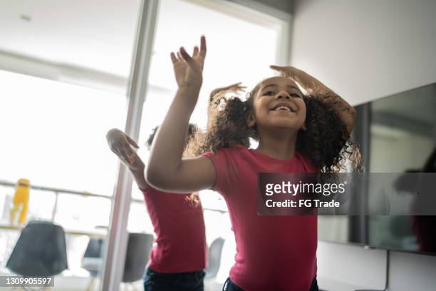 happy sisters dancing together at home - family singing stock pictures, royalty-free photos & images