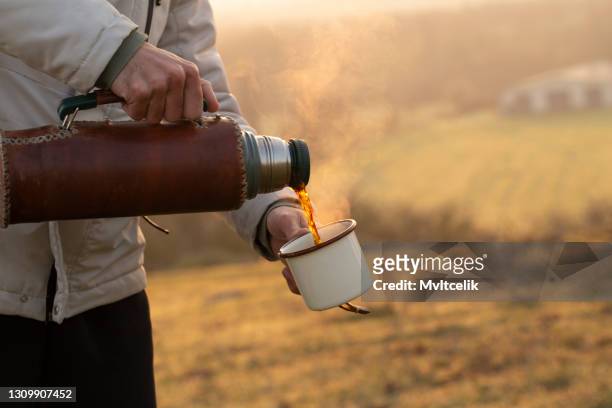pouring mug of coffee from a hot thermos - flask stock pictures, royalty-free photos & images