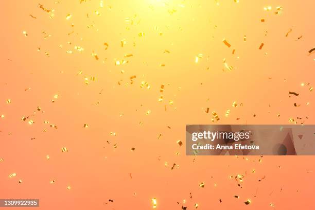 festive sparkling confetti for holidays on colored coral or orange background. front view. 3d - party background stock-fotos und bilder