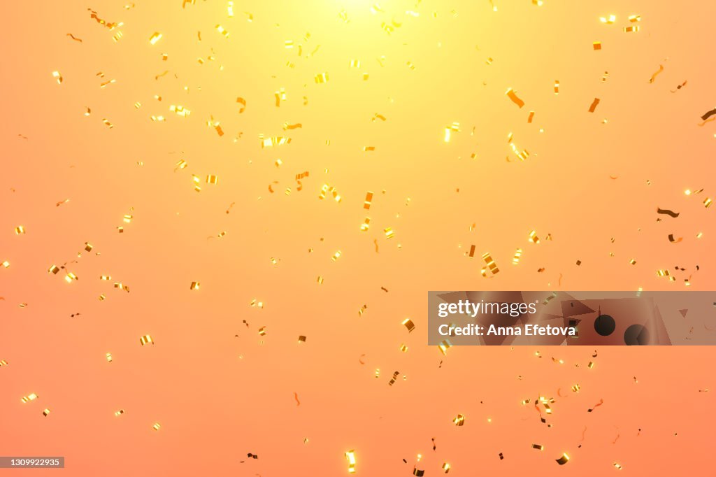 Festive sparkling confetti for holidays on colored coral or orange background. Front view. 3d
