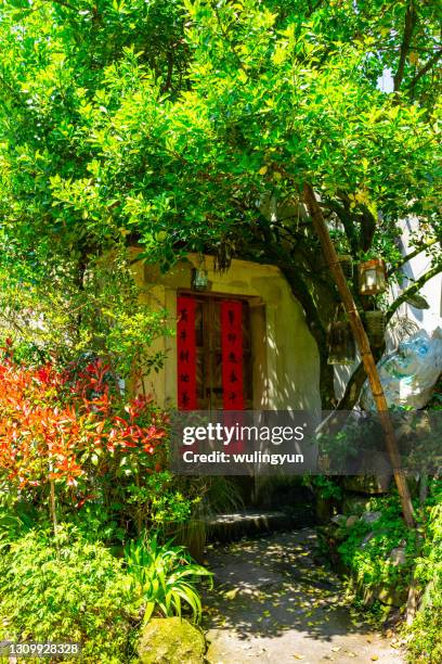 house front door covered by tree - anhui pastoral stock pictures, royalty-free photos & images