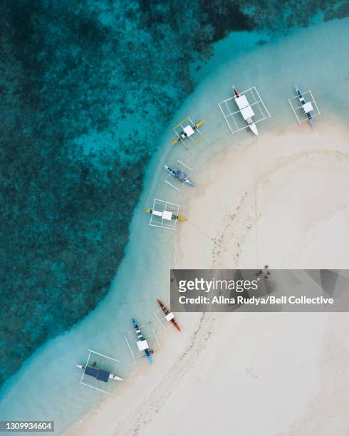 Aerial view of the boats by the sandy beach in the Philippines