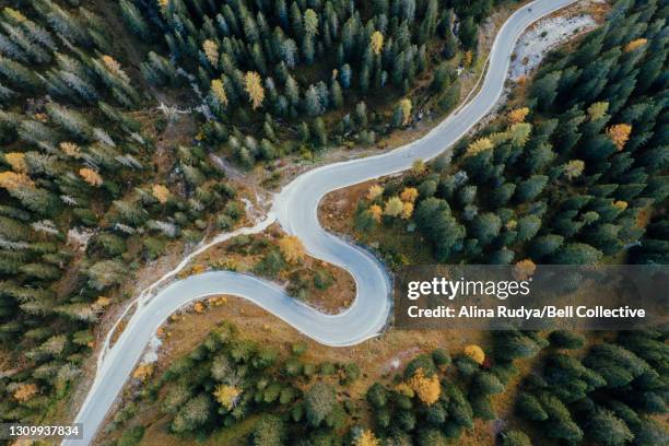 aerial view of a winding road in the alpine landscape - mountain pass stock pictures, royalty-free photos & images