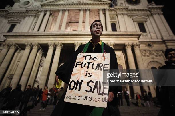 Protestor dressed as a Zombie carries a placard in front of St Paul's Cathedral on October 31, 2011 in London, England. The Dean of St Pauls...