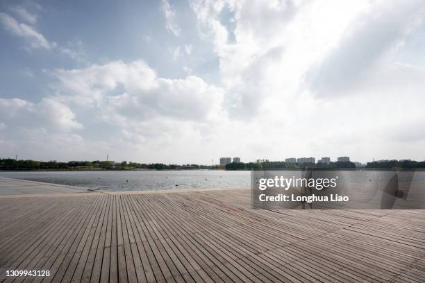 wooden platform by the water - jetty stock pictures, royalty-free photos & images