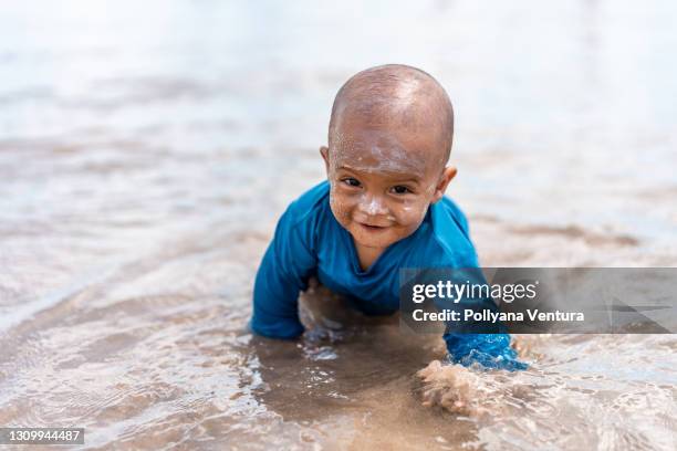 boy crawling on the beach - baby suncream stock pictures, royalty-free photos & images