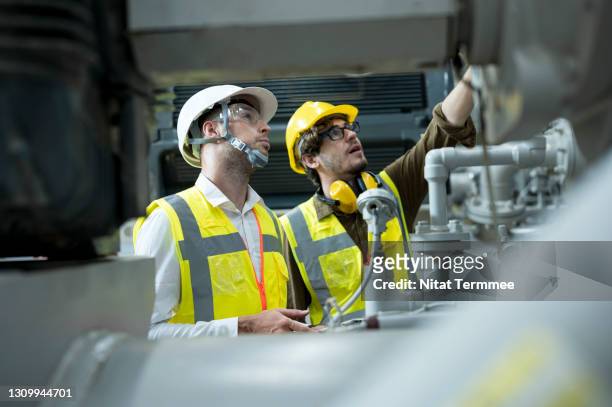 service engineer explaining to businessman about the hvac system ( heating, ventilation and air conditioning ) in control room shopfloor of factory. - employee safety stock pictures, royalty-free photos & images