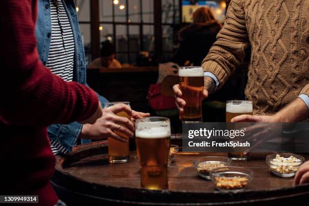 beer and snacks: group of unrecognizable men at the bar together, a close up - beer nuts stock pictures, royalty-free photos & images