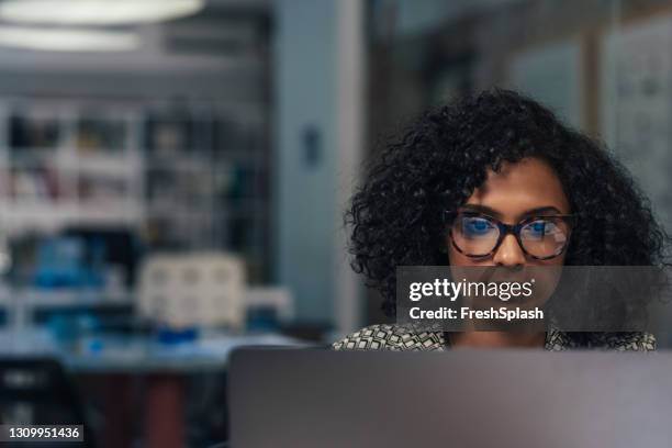 afroamerikanische geschäftsfrau arbeitet allein im büro, anpassung an die neue normalität - adapting stock-fotos und bilder