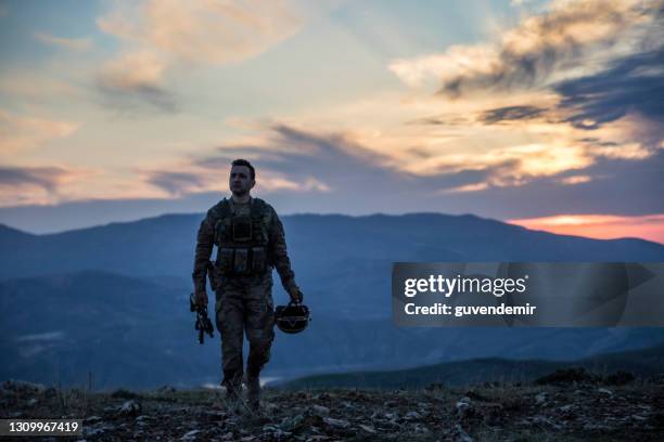 army soldier walking at sunset - military man stock pictures, royalty-free photos & images