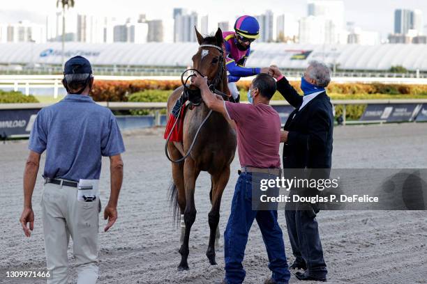 War Like Goddess, ridden by Julien Leparoux celebrates with horse trainer William Mott after winning the 56th running of the Orchid Grade III stakes...