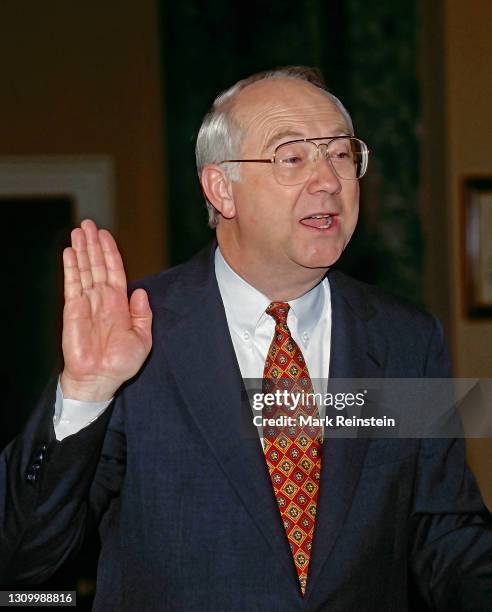 Senator Phil Gramm of Texas raises his right hand as he is sworn in by Vice President Albert Gore Jr. In the Old Senate Chambers on the opening day...