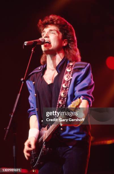 American Pop musician Richard Marx plays guitar as he performs onstage during his 'Repeat Offender' world tour at Radio City Music Hall, New York,...