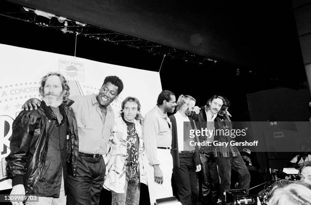 Portrait of, from left, musicians Levon Helm , Clarence Clemons , Nils Lofgren, Billy Preston , Ringo Starr, Joe Walsh, and Rick Danko during a press...