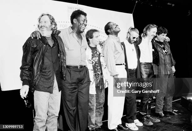 Portrait of, from left, musicians Levon Helm , Clarence Clemons , Nils Lofgren, Billy Preston , Ringo Starr, Joe Walsh, and Rick Danko during a press...