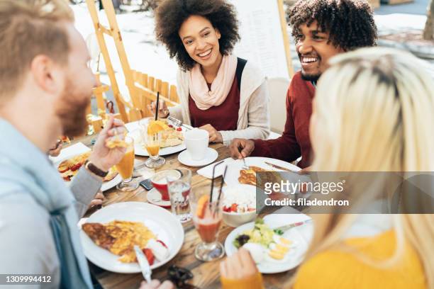 multi-ethnic group of friends - breakfast restaurant stock pictures, royalty-free photos & images