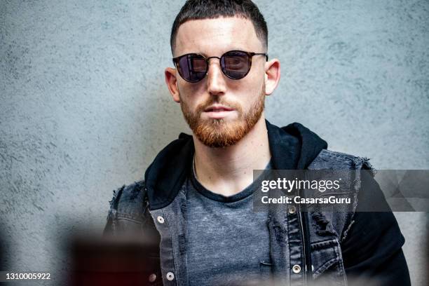 portrait of fashionable young adult man with sunglasses - short hair men stock pictures, royalty-free photos & images