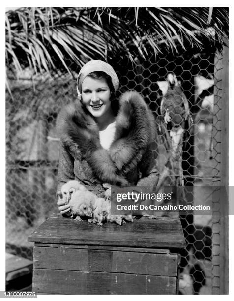 Actress Frances Dee is shown in Animal-land with the first monkey-faced owls to be born in captivity, as their mother’s nest of eggs was removed from...
