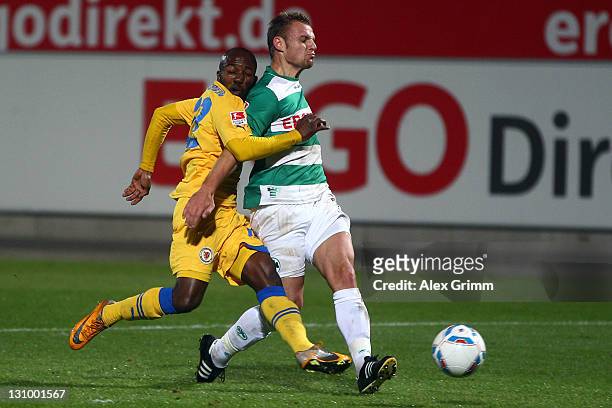 Dominick Kumbela of Braunschweig scores his team's first goal against Bernd Nehrig of Greuther Fuerth during the Second Bundesliga match between...