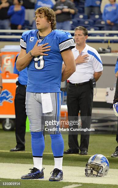 Matthew Stafford and head coach Jim Schwartz of the Detroit Lions look on during the National Anthem before the game against the Atlanta Falcons at...