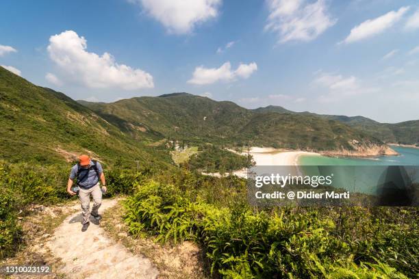 adult man hiking in the stunning sai kung wilderness area in the new territories in hong kong - sai kung village stock-fotos und bilder