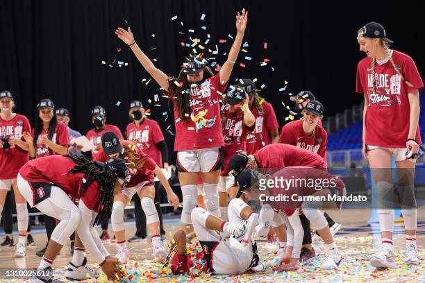 The Stanford Cardinal celebrate their win over the Louisville Cardinals in the Elite Eight round of the NCAA Women's Basketball Tournament at the...