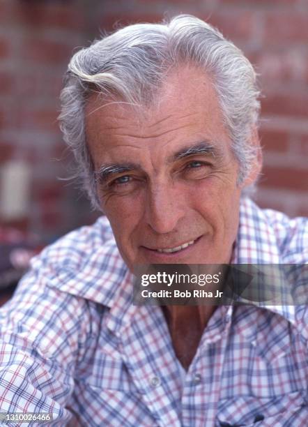 Rory Calhoun enjoys cooking BBQ ribs on his outdoor grill at home, February 22,1985 in Los Angeles, California.