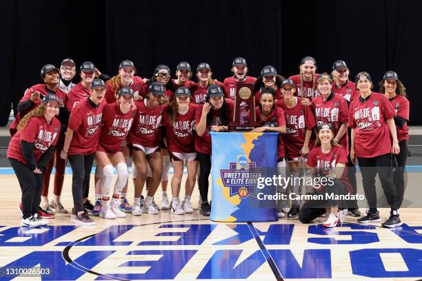 The Stanford Cardinal celebrate their win over the Louisville Cardinals in the Elite Eight round of the NCAA Women's Basketball Tournament at the...