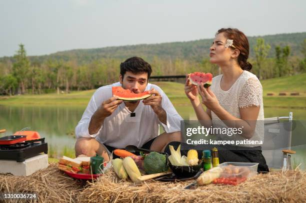 caucasian happy lover eating watermelon outdoor camping. - indoor picnic stock pictures, royalty-free photos & images