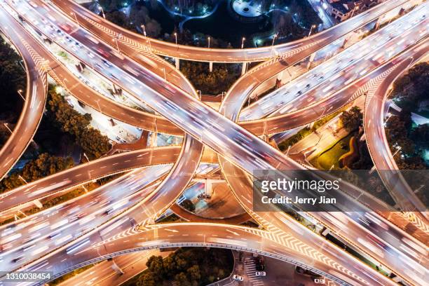 overpass in shanghai at night by the air drone - shanghai aerial view motorway skyline stock-fotos und bilder