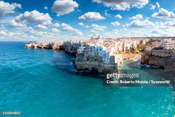 polignano a mare and blue sea in summer, puglia - puglia italy stock pictures, royalty-free photos & images