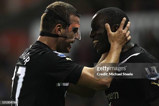 Demba Ba of Newcastle United celebrates scoring his sides second goal with Steven Taylor during the Barclays Premier League match between Stoke City...