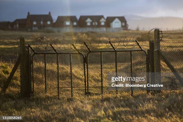 metal fence with razor wire - copeland cumbria stock pictures, royalty-free photos & images