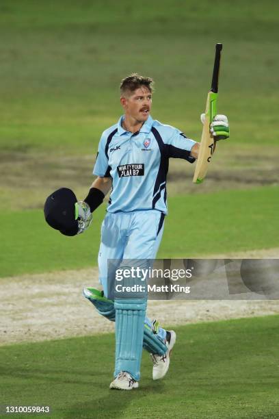 Daniel Hughes of New South Wales celebrates and acknowledges the crowd after scoring a century during the Marsh One Day Cup match between New South...