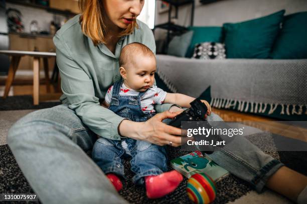 mother taking a photo of her baby. - photo shoot at home stock pictures, royalty-free photos & images