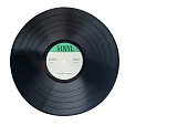 Closeup view of gramophone vinyl LP record or phonograph record with green label. Black musical long play album disc 12 inch 33 rpm spiral groove. Stereo sound record. Isolated on white background.