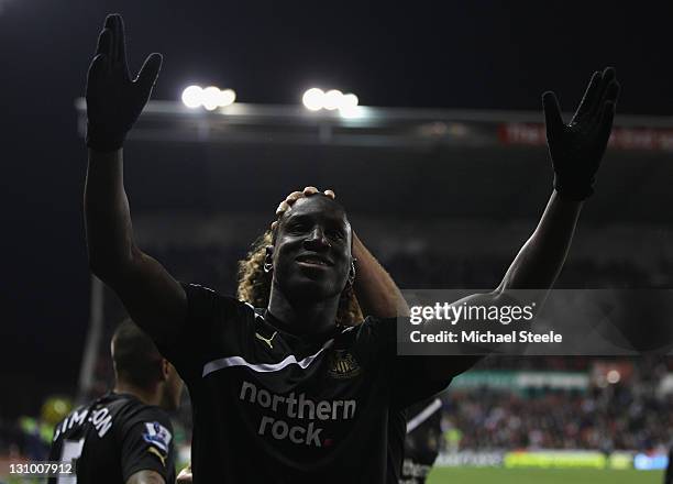 Demba Ba of Newcastle United celebrates scoring his third goal during the Barclays Premier League match between Stoke City and Newcastle United at...