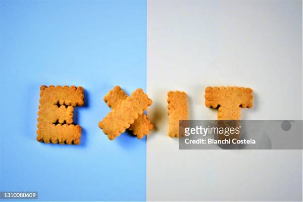 the word exit made of cookies - exit sign white background stock pictures, royalty-free photos & images