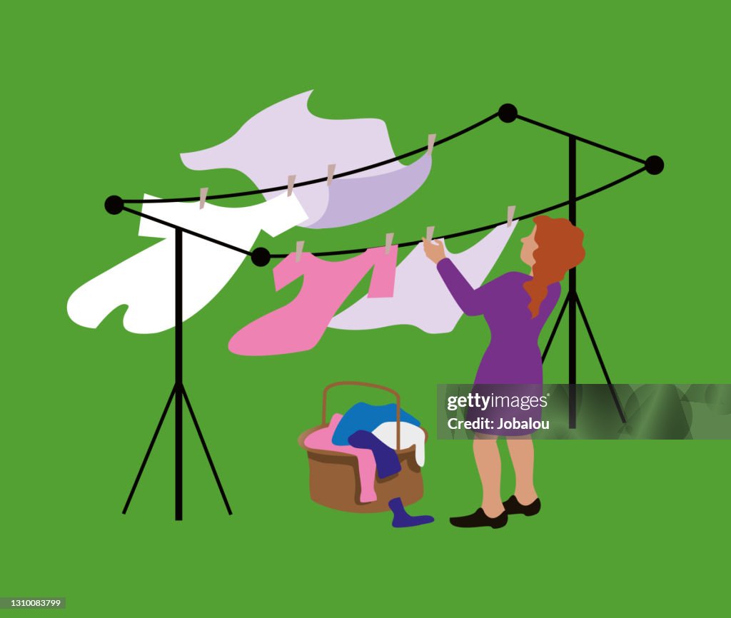 Woman Hanging Up Laundry In The Wind