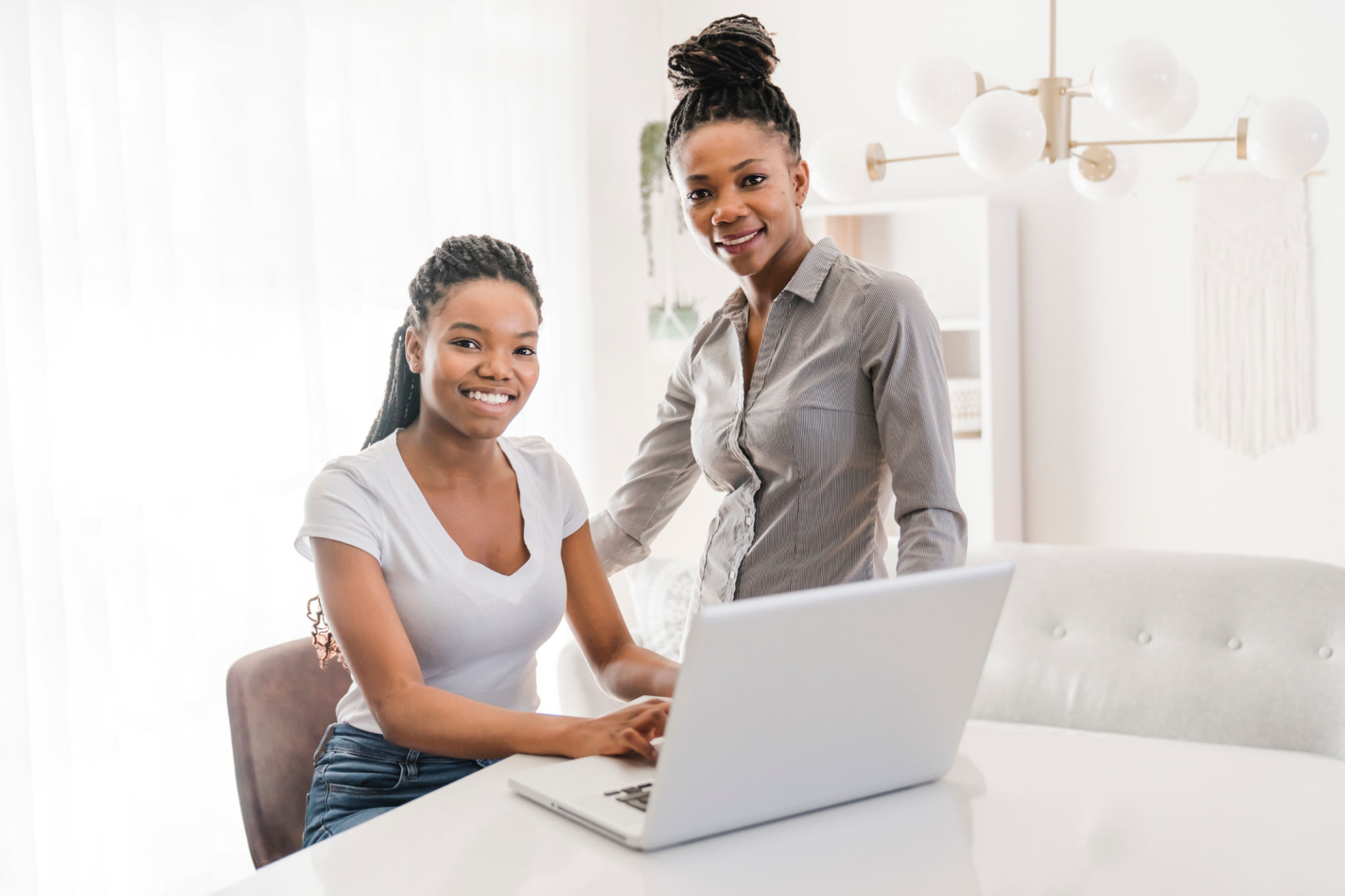 Mother And Teenage Daughter Looking At Laptop Together Mother And Teenage Daughter Looking At Laptop Together