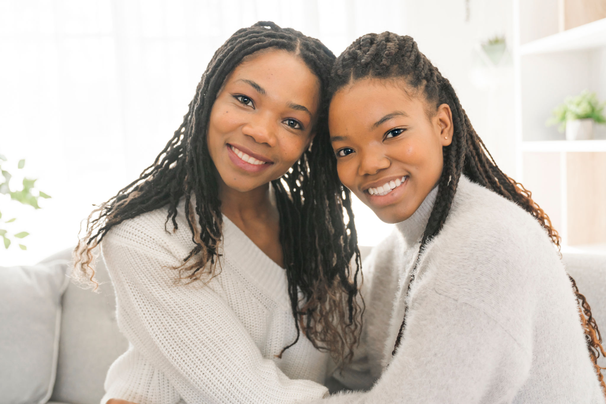 Mother and daughter sitting on sofa at home Mother and daughter sitting on sofa at home