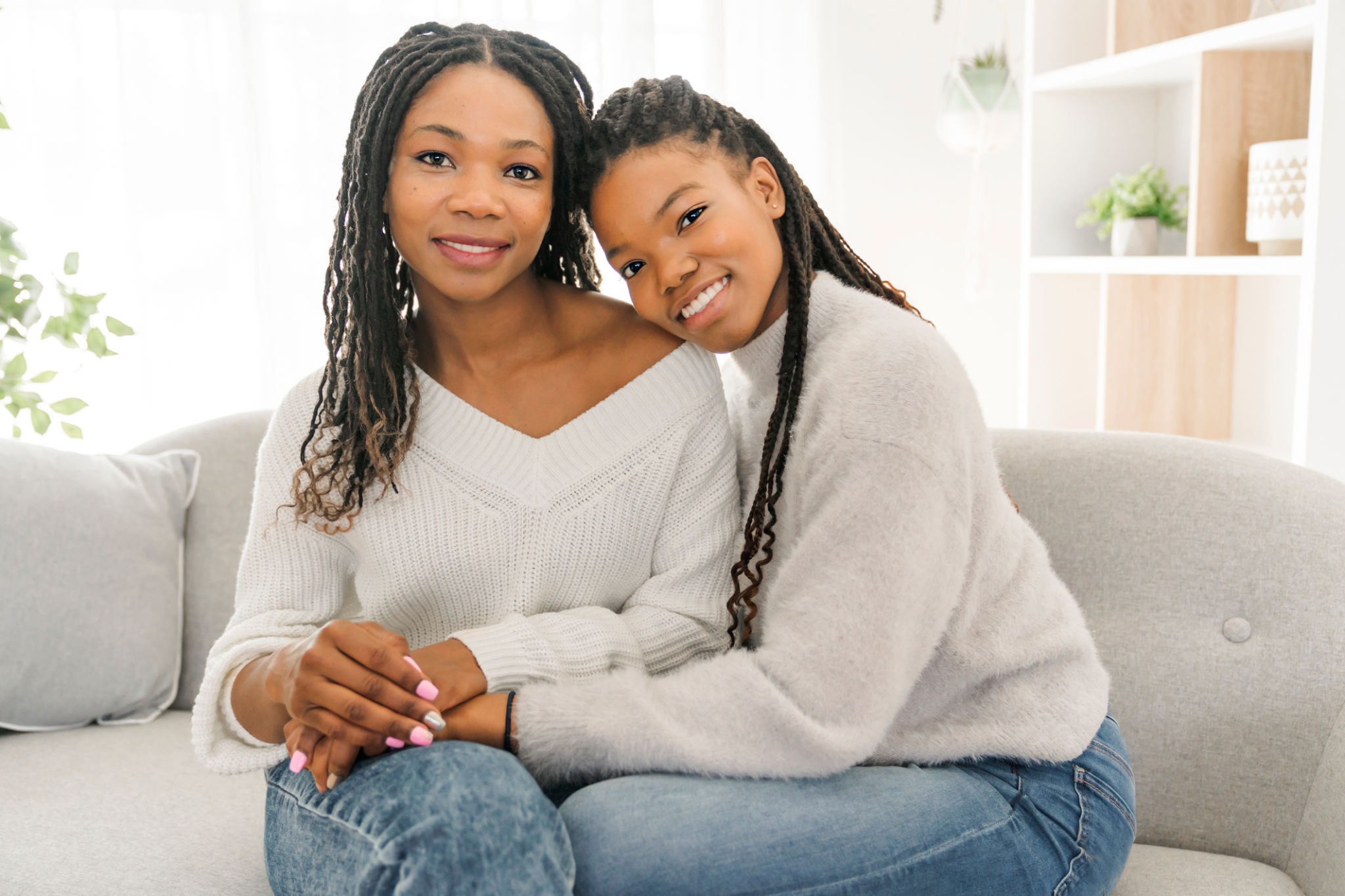 Mother and daughter sitting on sofa at home Mother and daughter sitting on sofa at home
