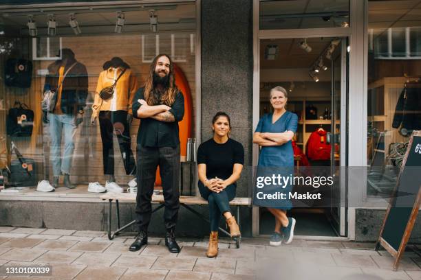 portrait of male and female colleagues outside clothes store - sports equipment store stock pictures, royalty-free photos & images