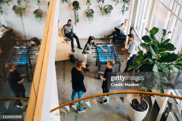 high angle view of business people taking break in office after meeting - coworking space stock pictures, royalty-free photos & images