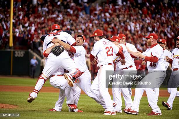 World Series: St. Louis Cardinals Yadier Molina and teammates victorious on field after game vs Texas Rangers at Busch Stadium. Game 7. Pile on. St....