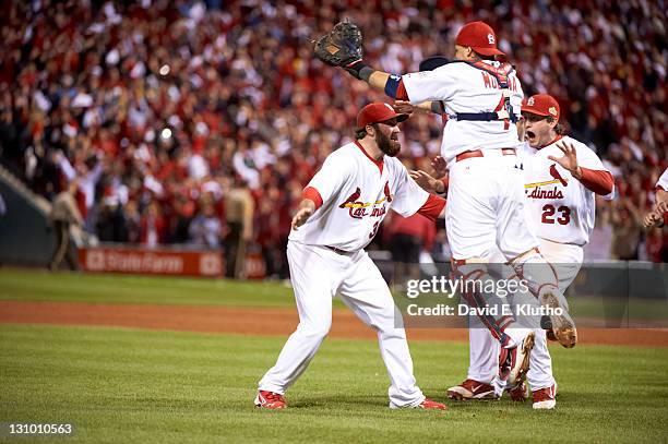 World Series: St. Louis Cardinals Yadier Molina , Jason Motte , and David Freese victorious on field after game vs Texas Rangers at Busch Stadium....