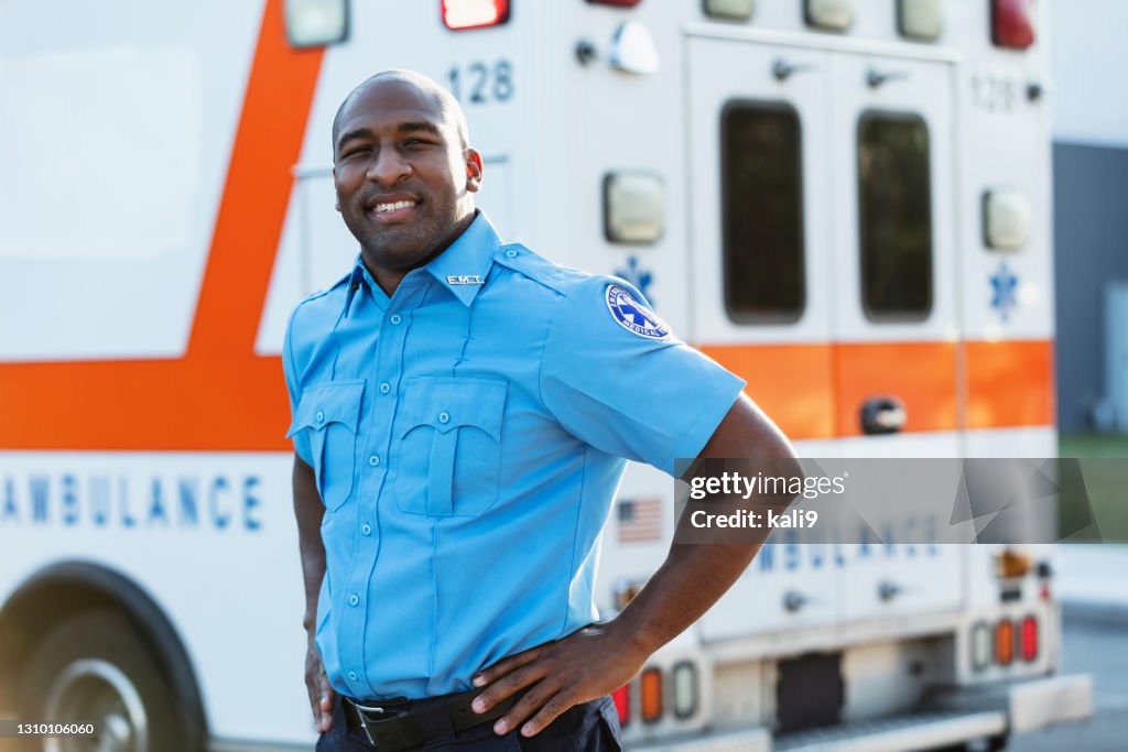 Paramedic in front of ambulance
